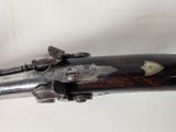 an old gun that is on display in a museum