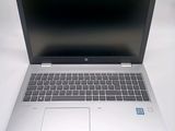 an open laptop computer sitting on top of a white table