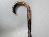 a close up of a wooden stick with a metal handle