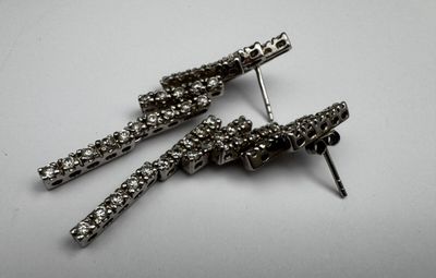 pair of black and white rhine earrings on a white surface