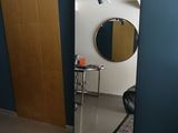 a room with a mirror and a rug on the floor