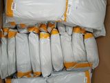 a cardboard box filled with bags of white stuff