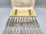 an assortment of silverware including knives, knives, and a case