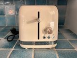 a toaster that is sitting on a tiled floor