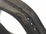 a close up of a leather strap with holes on it