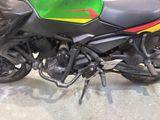 a green and yellow motorcycle parked in a garage