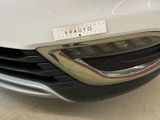 the front end of a white car with a sticker on it