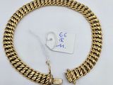 a gold chain bracelet with a clasp on a white background