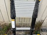 an image of a ladder leaning against a wall with a sign attached to it