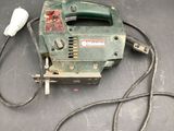 a small corded tool on a table with a cord