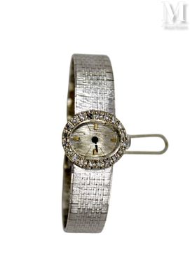 an image of a woman ' s wrist watch with a diamond bezel