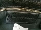 an image of a close up of a black purse with a label on it