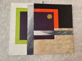 three different colored paintings hanging on a wall next to each other