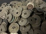 a pile of old coins sitting on a table