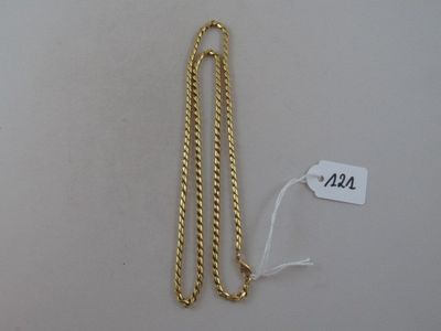 a close up of a gold chain on a white surface