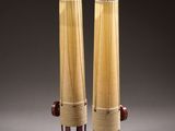 two tall vases that are made out of wood