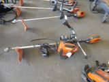 many lawn mowers that are lined up on the floor