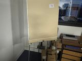 a white board that is on a stand in a room