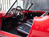 a red car with black leather seats and a steering wheel