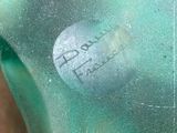 a close up of a person ' s hand holding a piece of glass