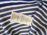 a close up of a blue and white striped shirt with a label on it