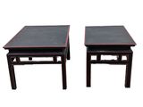 a pair of chinese style tables with black tops