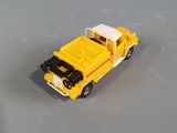 a yellow toy car that is sitting on a table