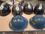 several helmets are lined up on a table in a warehouse