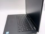 a laptop with a black keyboard on a white surface