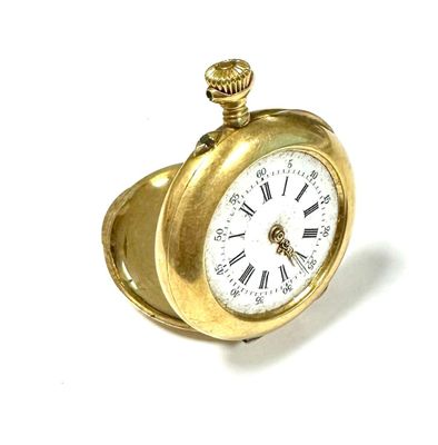 a gold pocket watch with roman numerals on it
