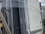 a lot of windows that are stacked up on a pallet