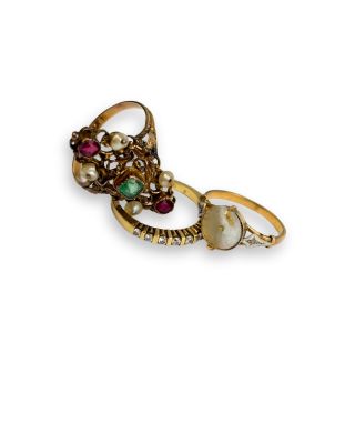 an image of a pair of gold rings with pearls and gems