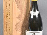 a bottle of wine sitting next to a wooden box