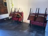 many chairs that are lined up in a room