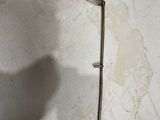 a small scythe on the floor next to an open book