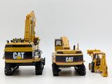 two toy construction vehicles that are sitting next to each other