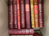 many books in the box on the shelf