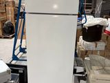 a refrigerator that is sitting in a warehouse with boxes