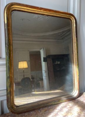 a large mirror sitting on a table in a room
