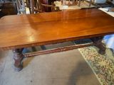 a large wooden table that is sitting in a room