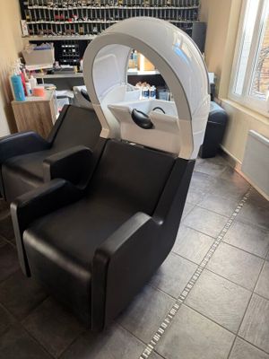 an image of a salon chair with a hair dryer on it
