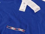 a blue t - shirt with a red, white and blue design on it
