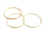 three gold wedding rings on a white background