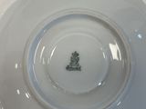 a white plate with a crown on it sitting on a table