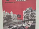the poster for the monaco 2000 race is displayed on a table