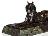 bronze sculpture of a dog laying on a marble base