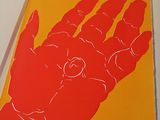an open book with a picture of a hand holding a button on it