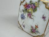 a vase with flowers on it sitting on a table
