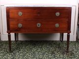 a small wooden chest of drawers with marble top