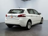 the rear end of a white car is parked in a room